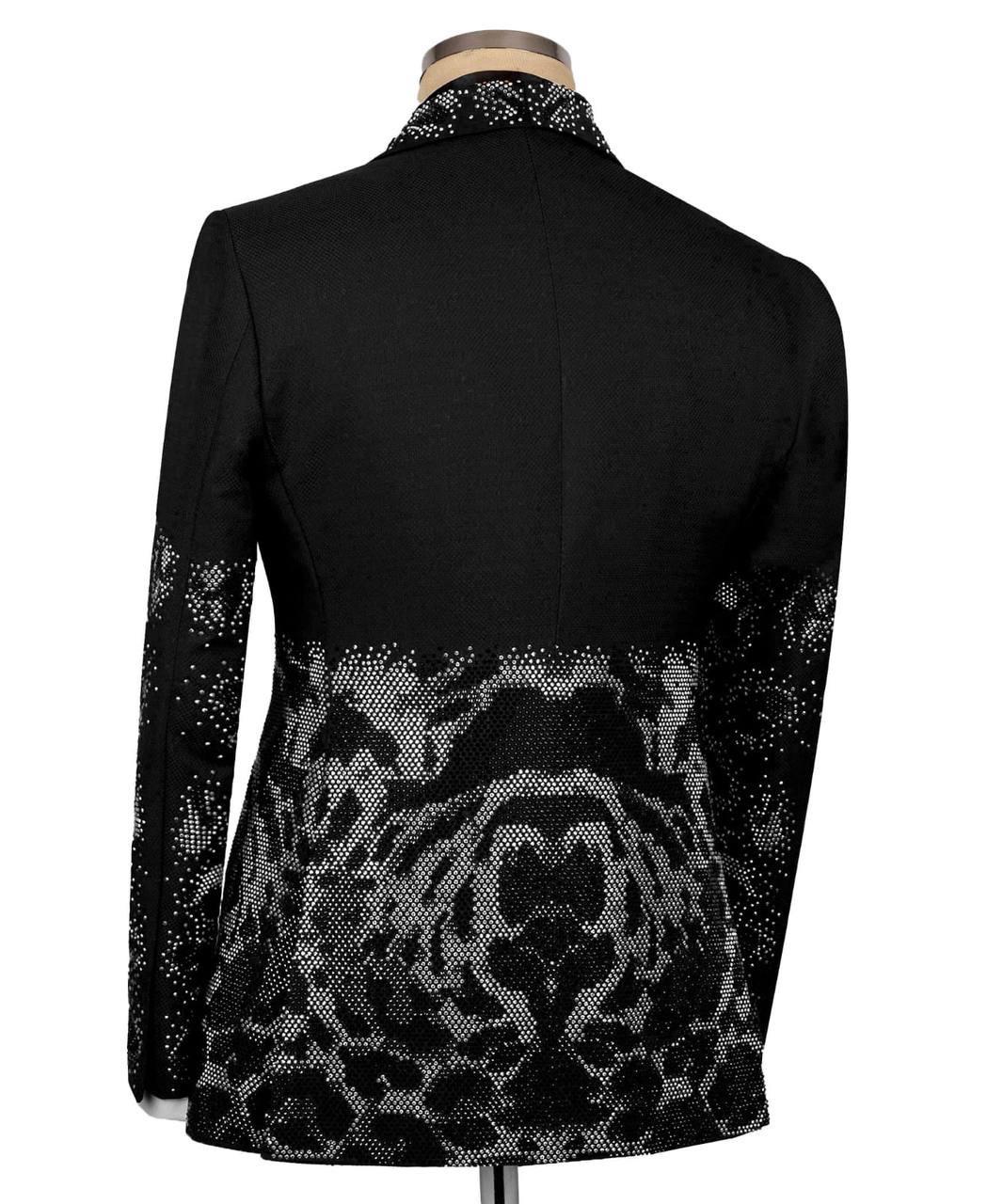 Black jacket with silver sequin patterns on a mannequin against a white background