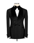 A black double-breasted tuxedo jacket with a textured pattern, black satin shawl collar, and black bow tie, displayed on a mannequin torso with a white shirt.