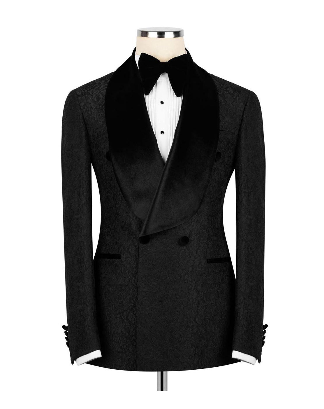 A black double-breasted tuxedo jacket with a textured pattern, black satin shawl collar, and black bow tie, displayed on a mannequin torso with a white shirt.
