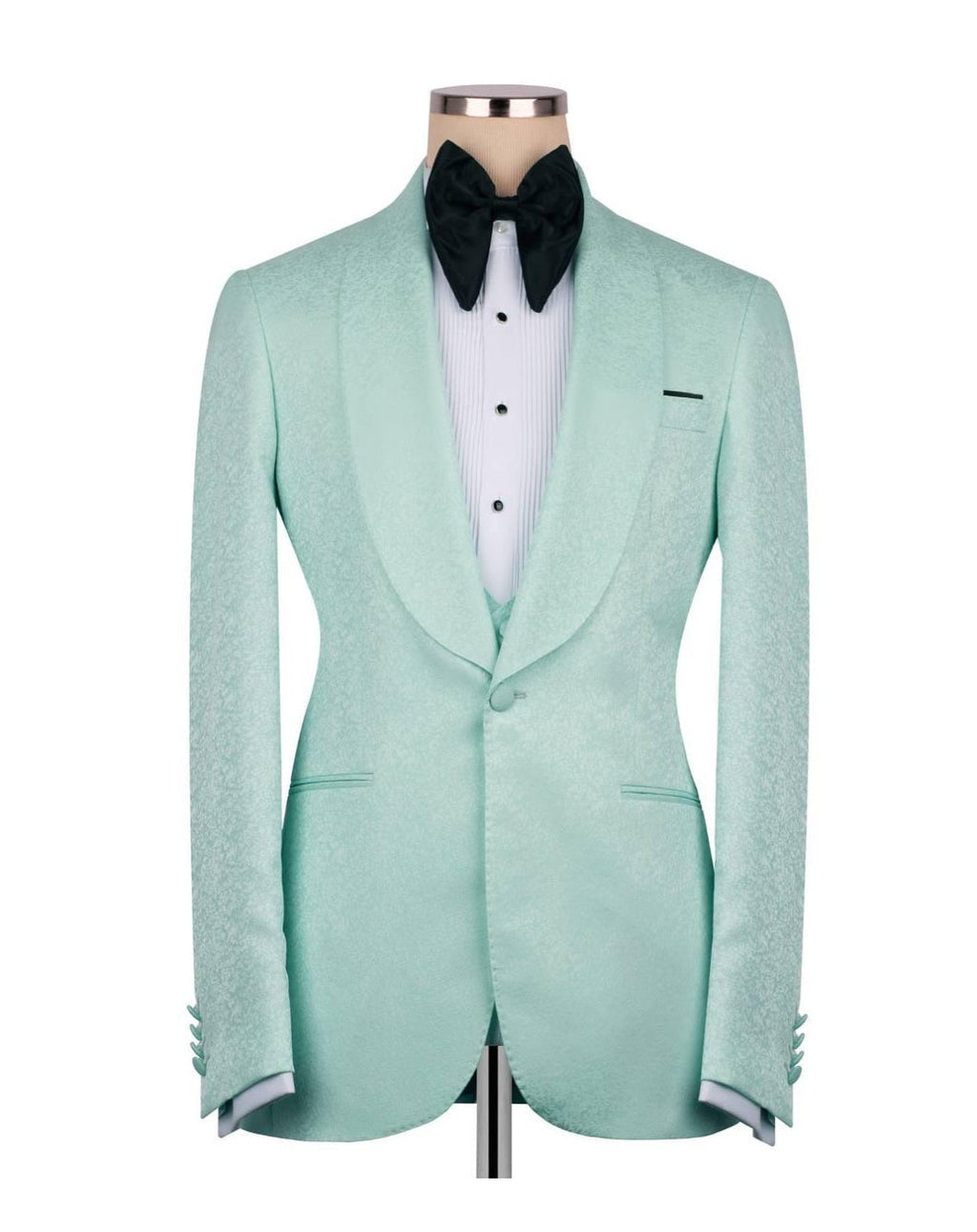 A mint green textured tuxedo jacket displayed on a mannequin torso, styled with a white pinstripe shirt and a black bow tie against a plain white background.
