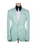 A mint green textured tuxedo jacket displayed on a mannequin torso, styled with a white pinstripe shirt and a black bow tie against a plain white background.