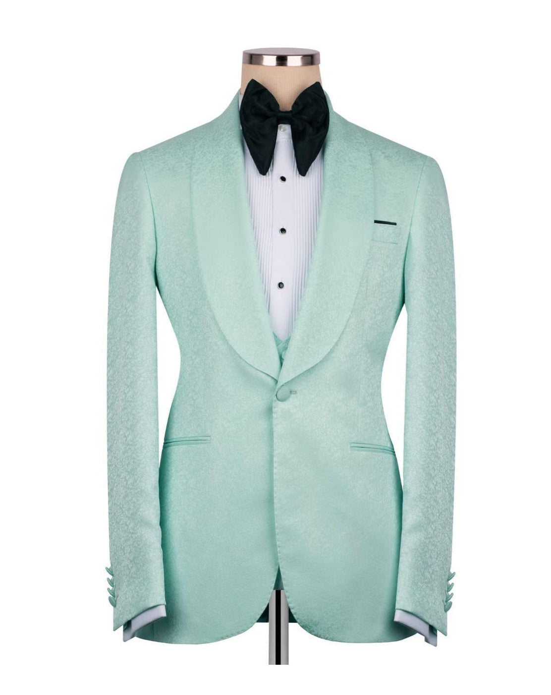 A mint green textured tuxedo jacket displayed on a mannequin torso, styled with a white pinstripe shirt and a black bow tie against a plain white background.