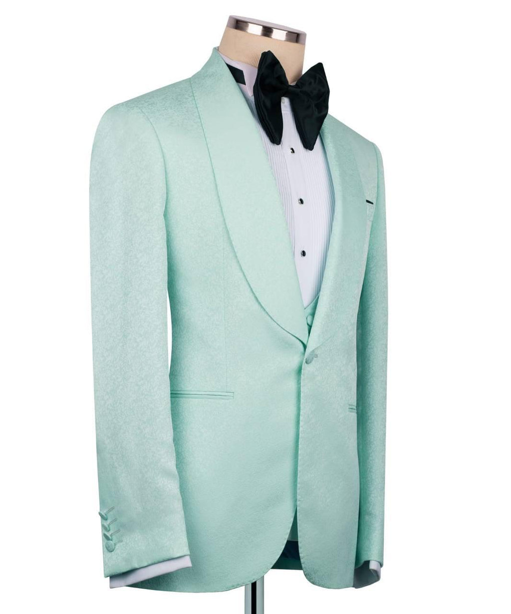 A mint green tuxedo jacket displayed on a mannequin torso, styled with a white dress shirt, black bow tie, and matching mint green vest against a plain white background.