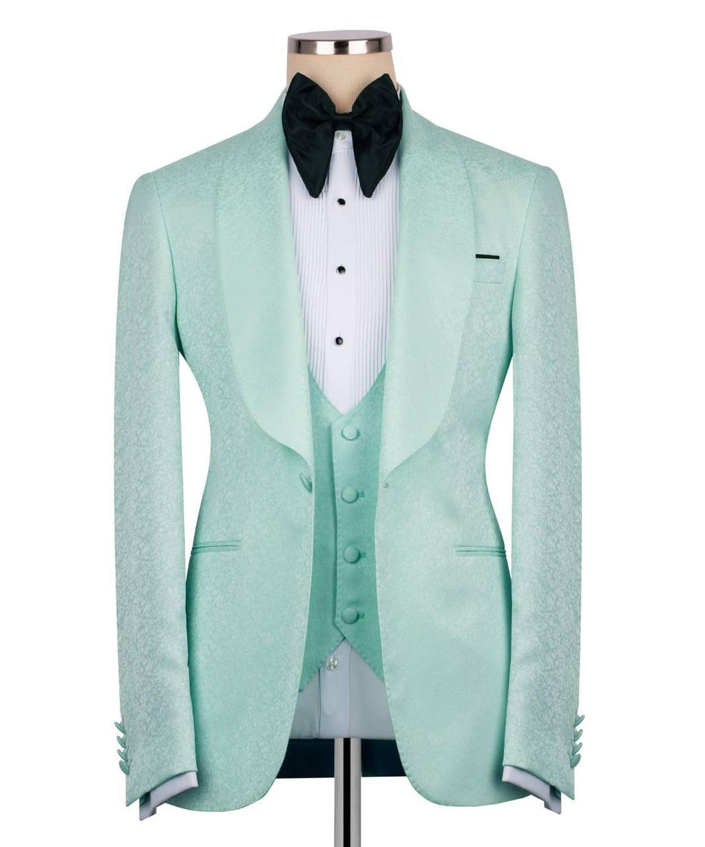 A mint green tuxedo jacket with satin peak lapels, displayed on a mannequin with a matching mint green vest, white pinstripe shirt, and black velvet bow tie against a white background.