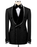 A men's black double-breasted tuxedo jacket with a textured pattern, black velvet shawl collar, and silver trim, displayed on a mannequin with a white shirt and black bow tie.