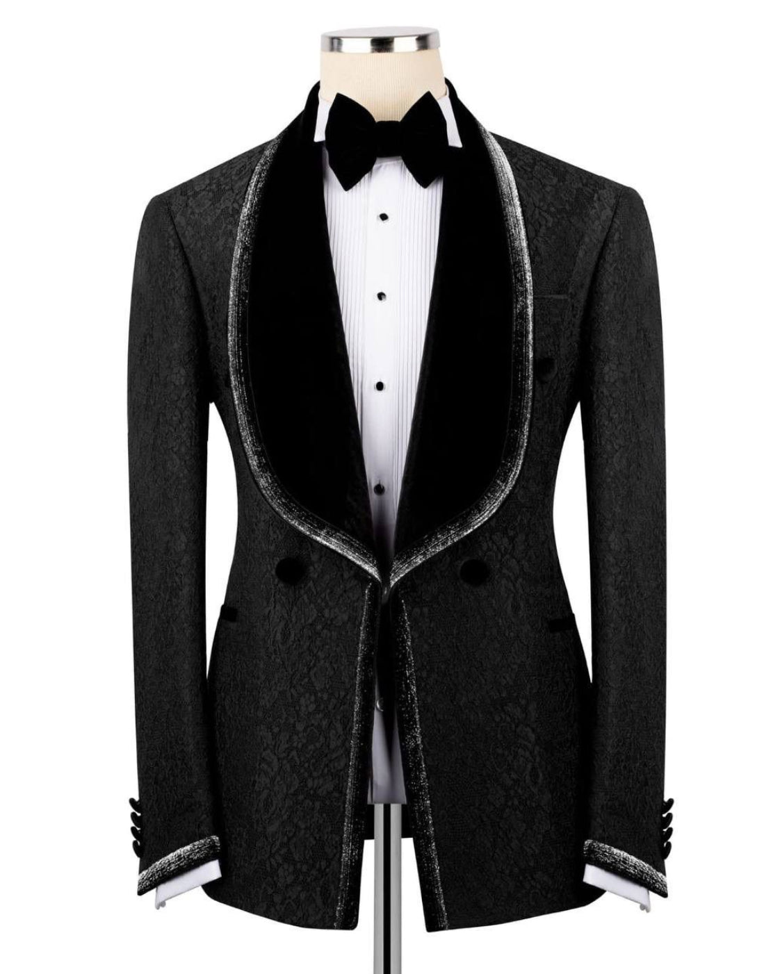 Black tuxedo jacket with white shirt and bow tie on a mannequin against a white background