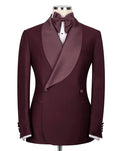 A men's double-breasted tuxedo jacket in deep burgundy, styled with satin peak lapels, a matching burgundy bow tie, and a white dress shirt on a mannequin torso against a light gray background.