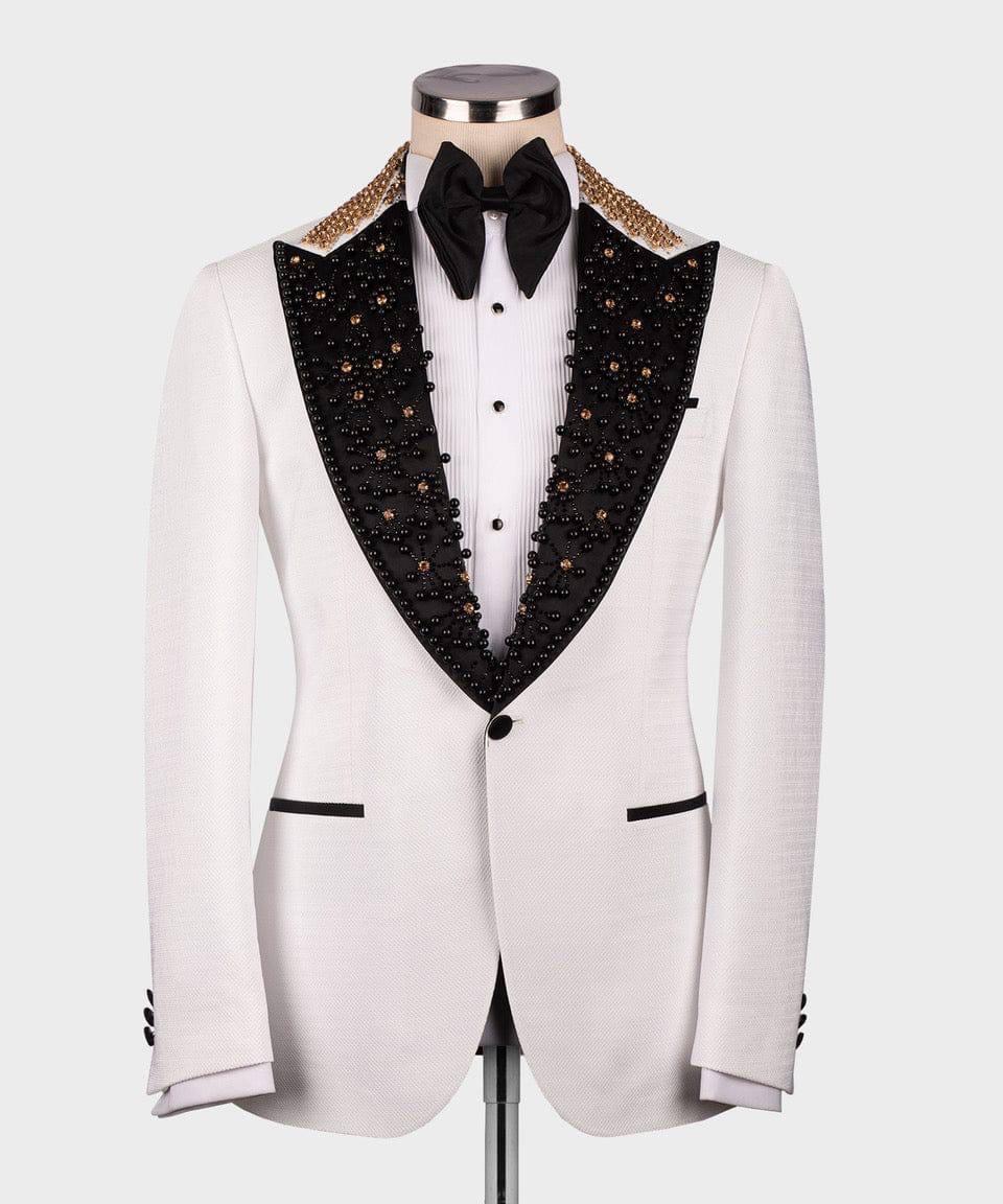 White tuxedo with black lapels and gold embellishments on a mannequin against a white background