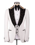 A white tuxedo jacket displayed on a mannequin, featuring black peak lapels heavily embellished with gold and black beads, a white pinstripe shirt, a black bow tie, and a matching white vest.