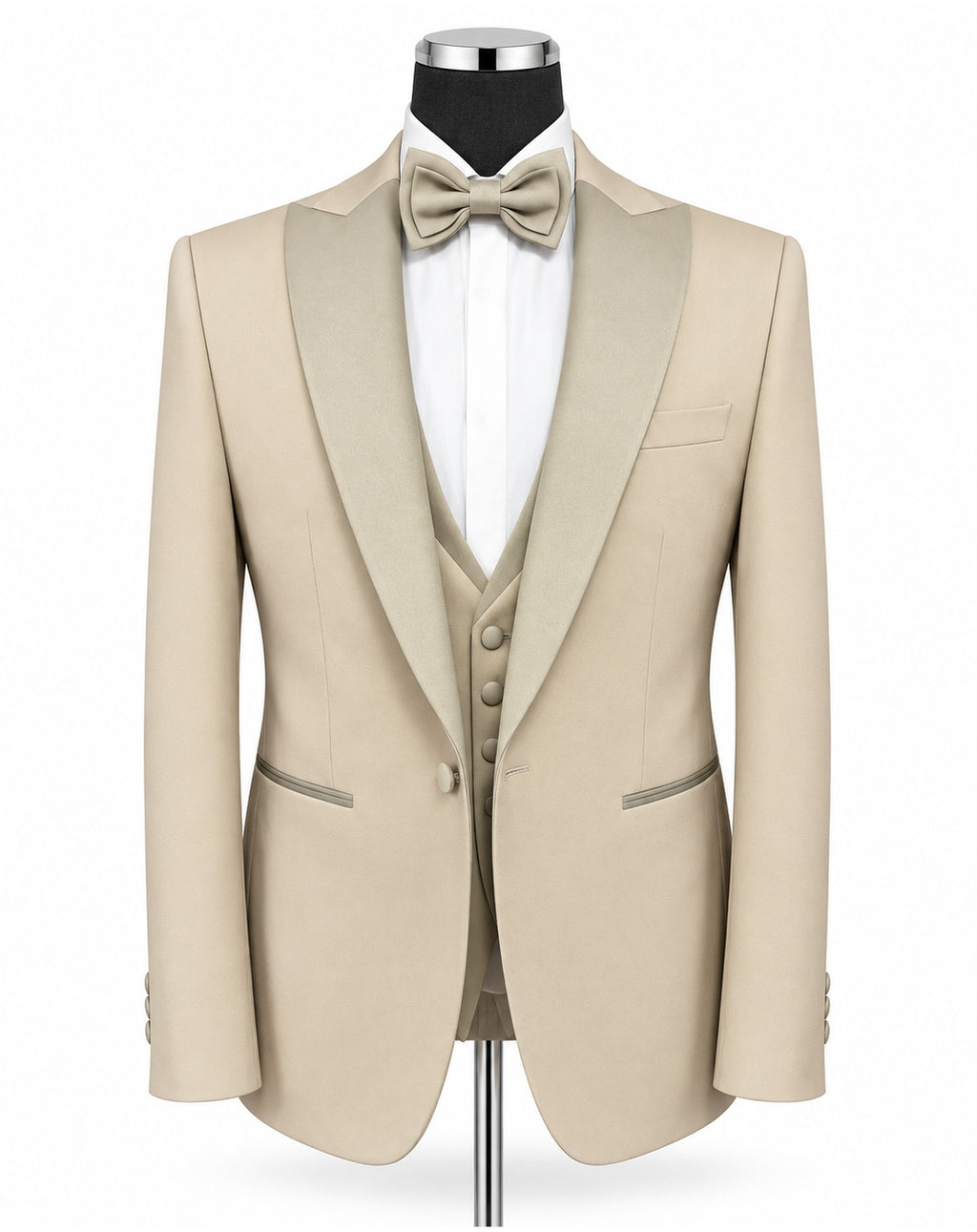 A beige tuxedo jacket with satin peak lapels, displayed on a mannequin with a matching beige bow tie, white dress shirt, and matching beige vest against a plain white background.