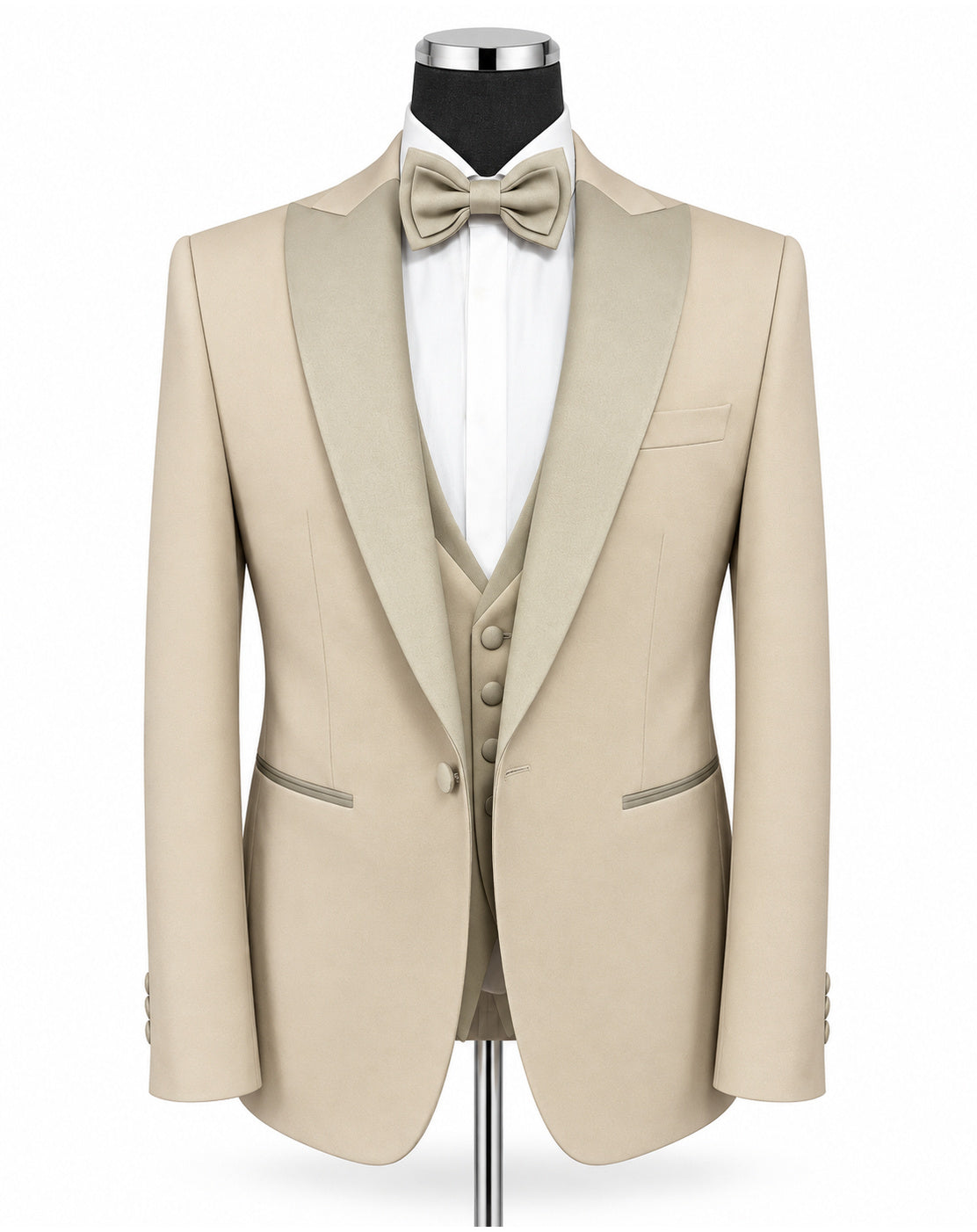 A beige tuxedo jacket with satin peak lapels, displayed on a mannequin with a matching beige bow tie, white dress shirt, and matching beige vest against a plain white background.