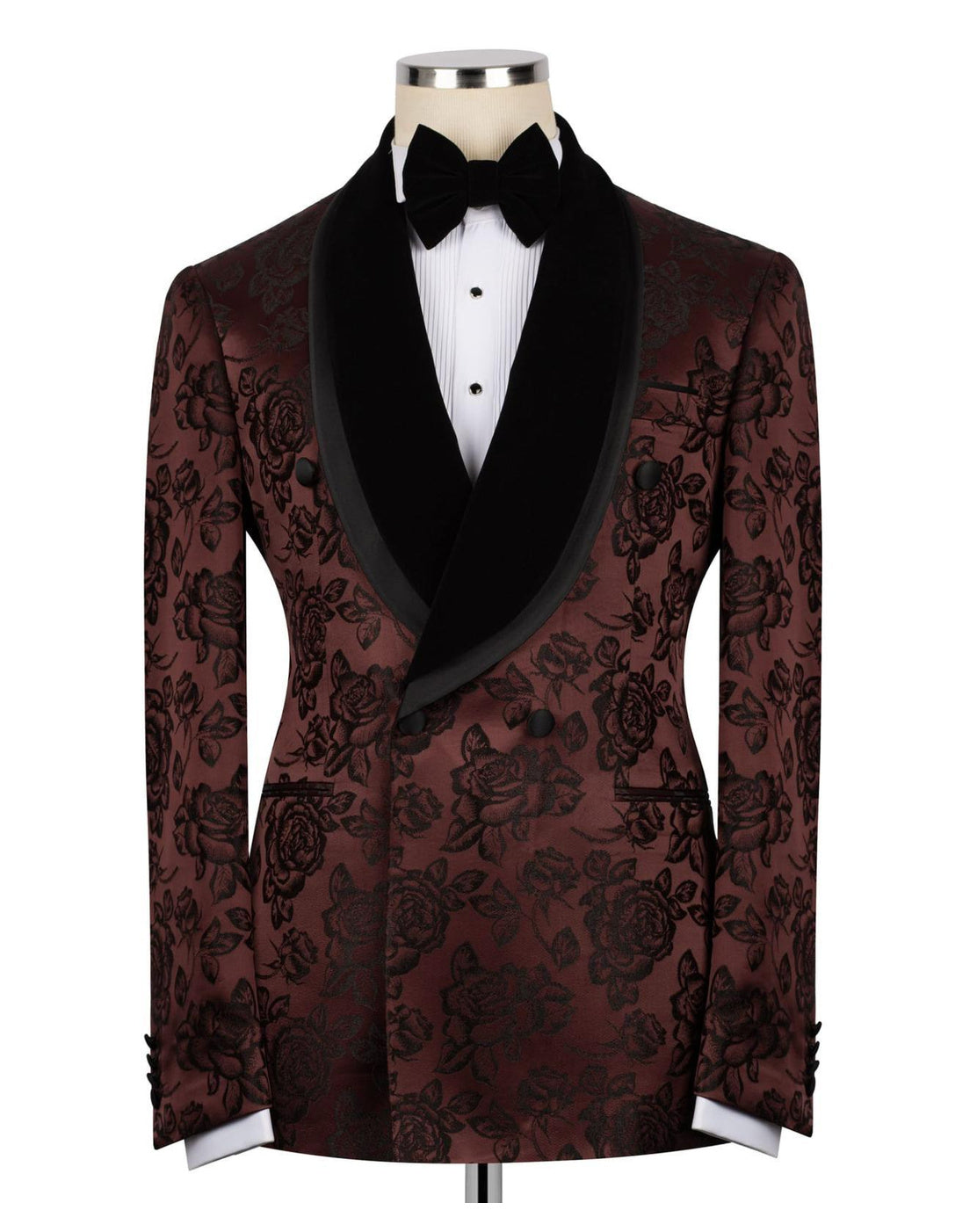A men's tuxedo jacket with a dark brown and black floral brocade pattern, black satin shawl collar, and a black bow tie, displayed on a mannequin torso against a white background.