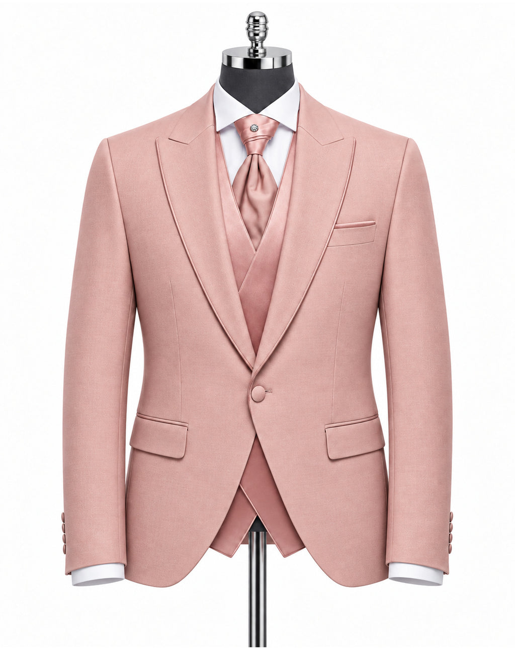 A men's three-piece suit in dusty pink, displayed on a black mannequin torso. The set includes a single-breasted blazer with peak lapels, a matching vest, a matching tie, a white dress shirt, and a white pocket square.