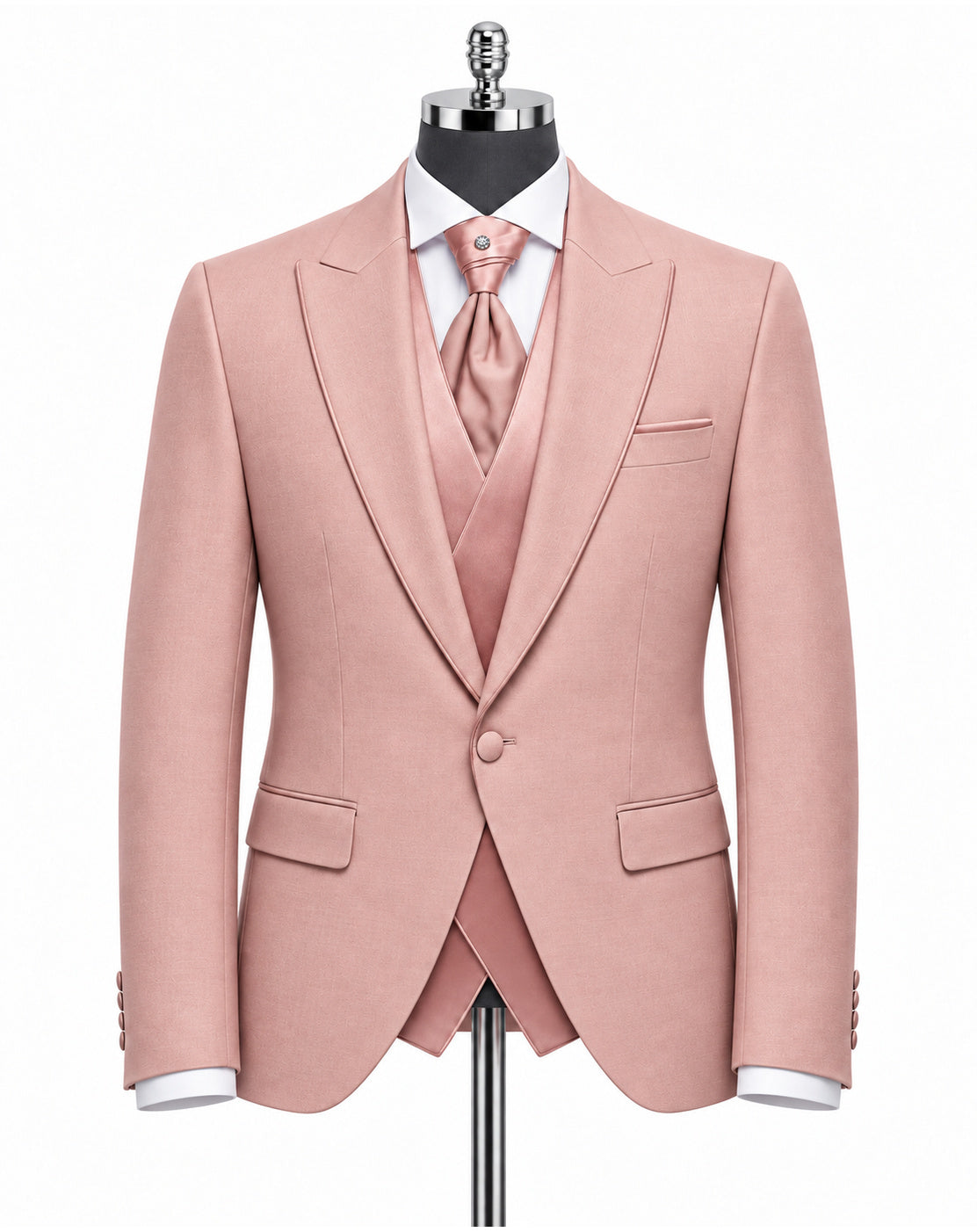 A men's three-piece suit in dusty pink, displayed on a black mannequin torso. The set includes a single-breasted blazer with peak lapels, a matching vest, a matching tie, a white dress shirt, and a white pocket square.