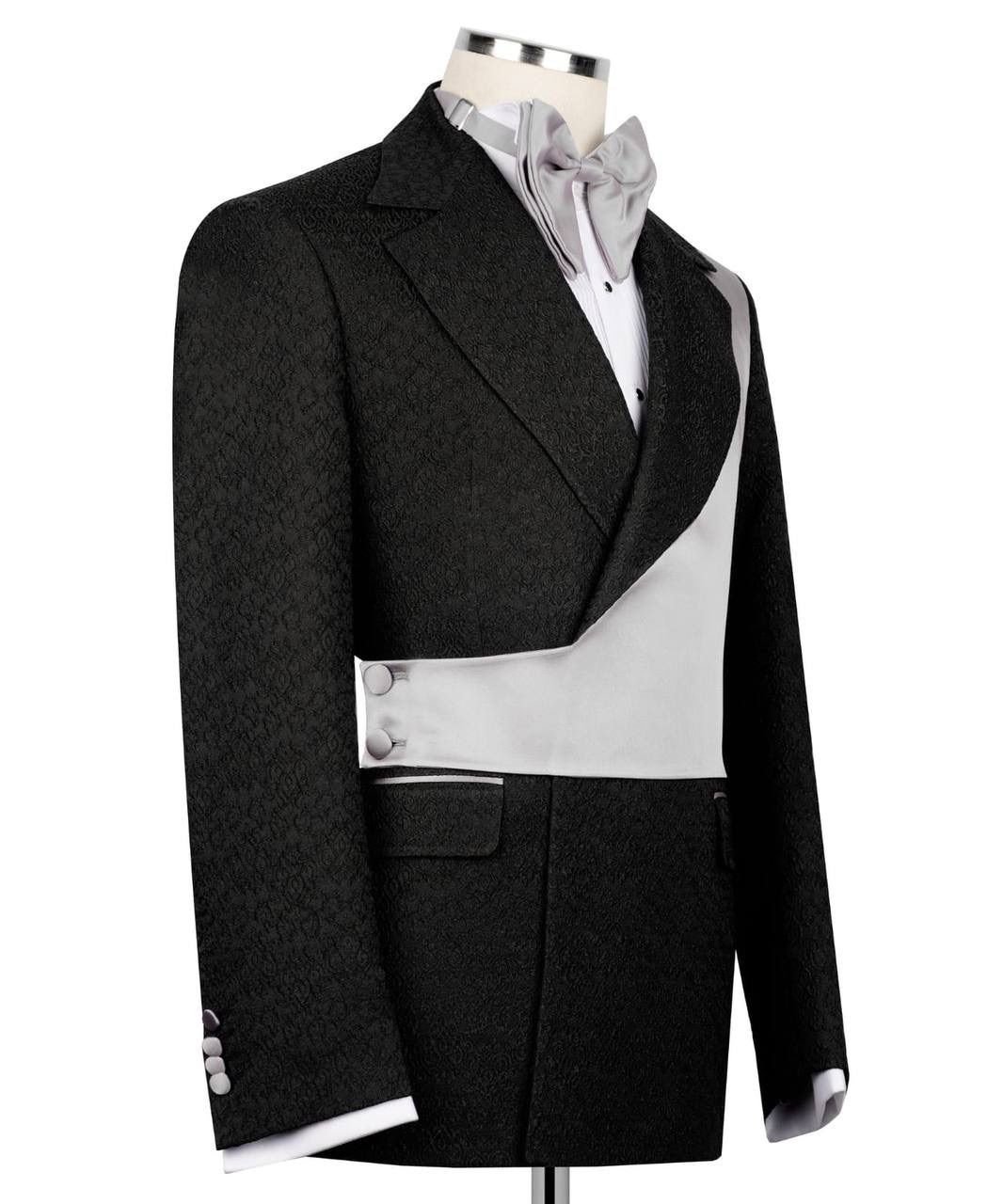 Black tailcoat on a mannequin with a white shirt and gray bow tie against a white background