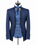 A men's formal suit displayed on a mannequin against a white background, featuring a navy blue double-breasted jacket with black lace trim, a matching blue patterned vest, waistcoat, and tie, and a white dress shirt.