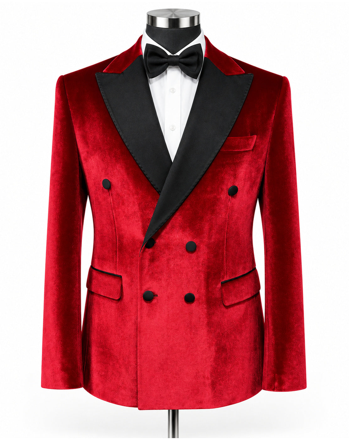 A men's double-breasted tuxedo jacket in red velvet with black satin peak lapels, displayed on a mannequin with a white dress shirt and black bow tie against a plain white background.
