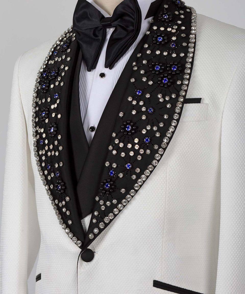 White tuxedo with black lapels and decorative stoles on a mannequin against a gray background