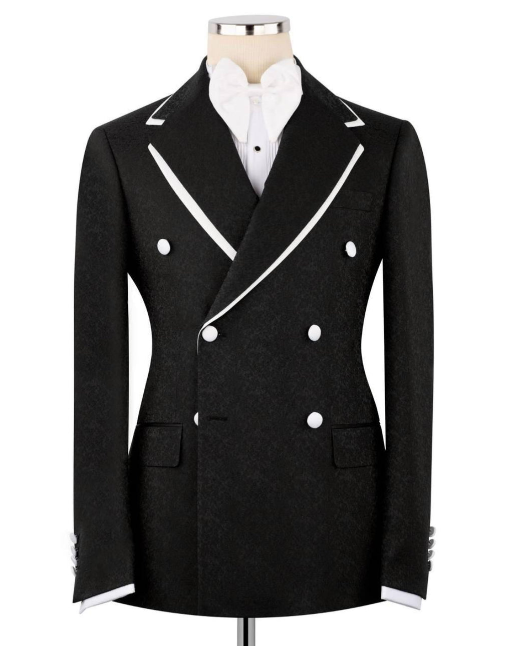 A black double-breasted blazer with white contrast piping and white buttons, displayed on a mannequin torso with a white shirt underneath, against a plain white background.
