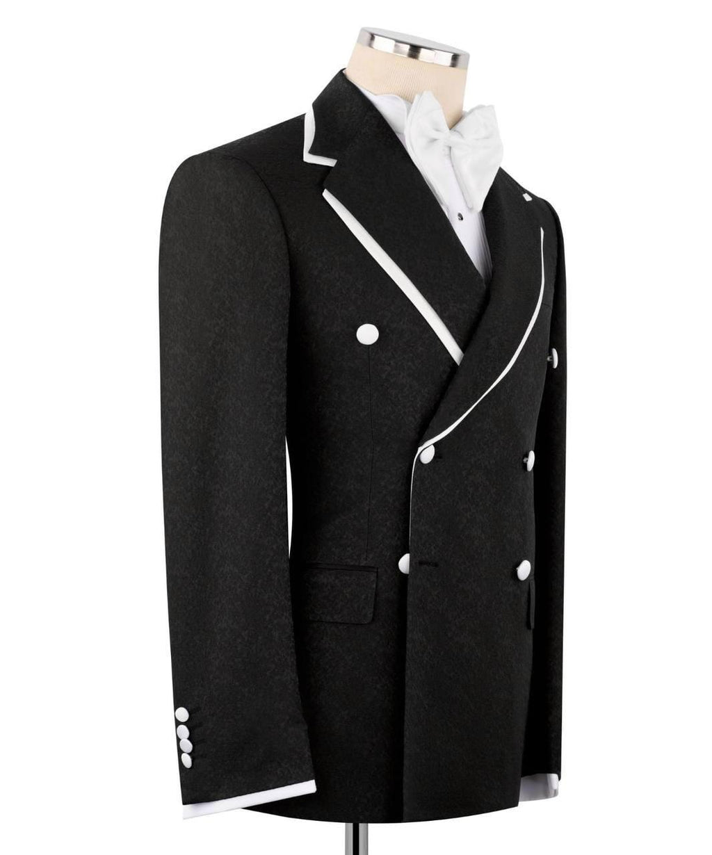 A black double-breasted tuxedo jacket with white piping and white buttons, displayed on a mannequin torso with a white shirt and bow tie against a plain white background.
