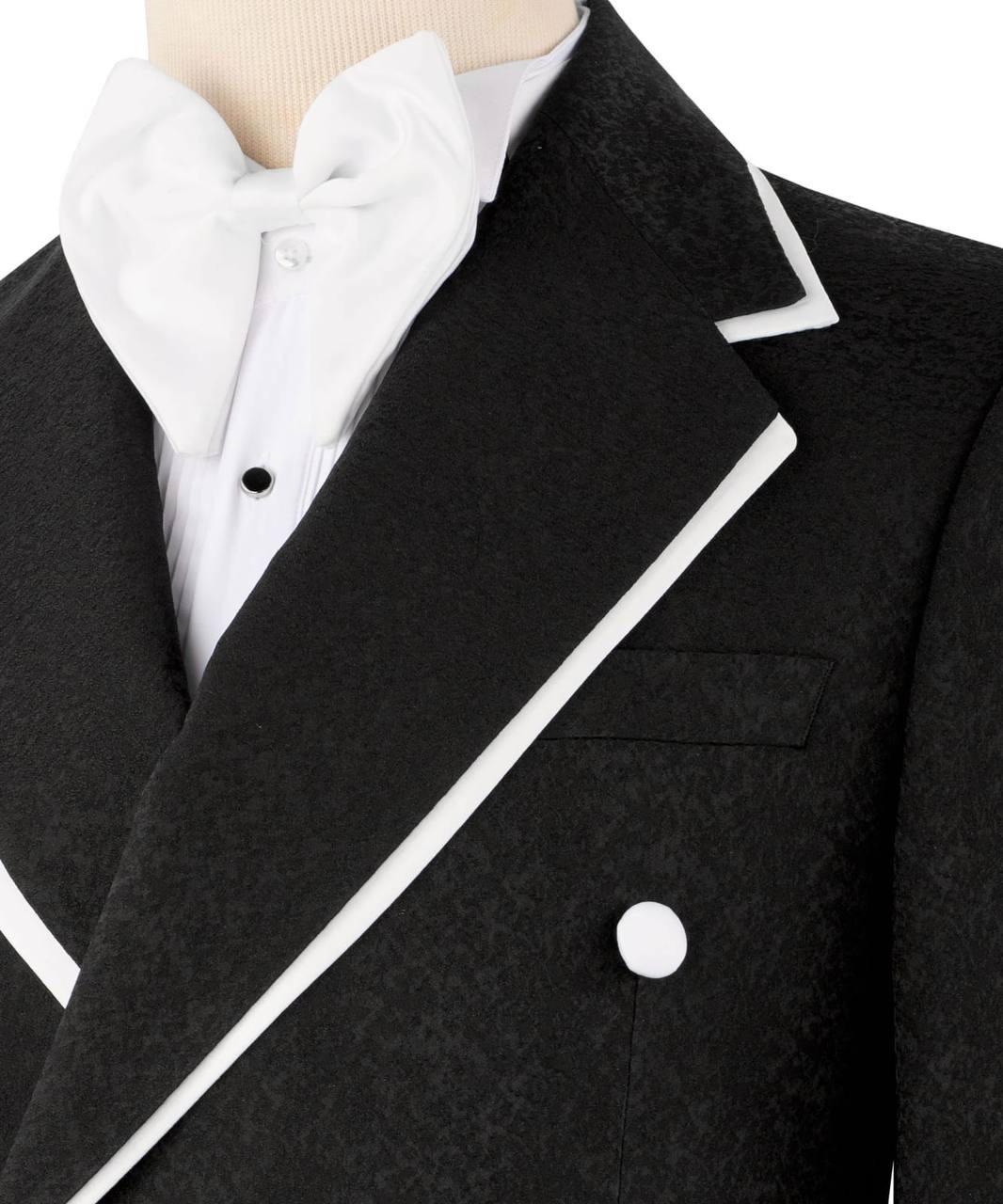 Close-up of a formal black tuxedo jacket with white contrast piping, worn over a white pleated shirt and white bow tie on a mannequin torso.