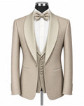 A men's formal tuxedo jacket with satin peak lapels in a light beige/champagne color, styled on a mannequin with a white dress shirt, matching beige bow tie, and a matching beige vest.
