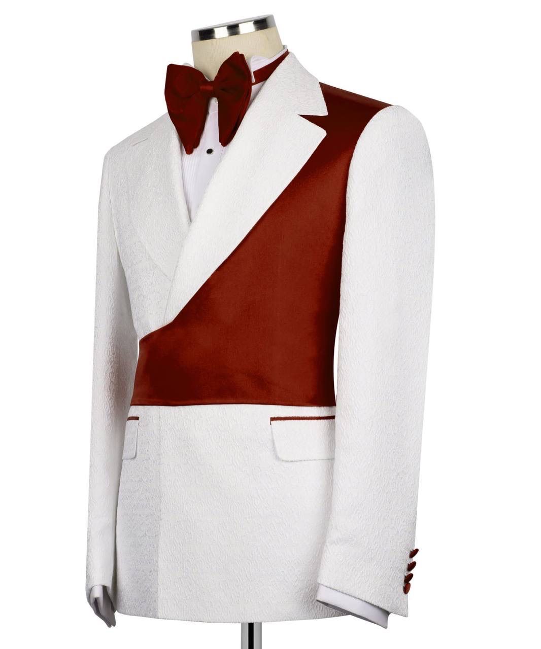 A men's tuxedo jacket displayed on a mannequin, featuring a white textured fabric body with a contrasting deep burgundy satin diagonal panel across the chest, a matching burgundy bow tie, and a white dress shirt.