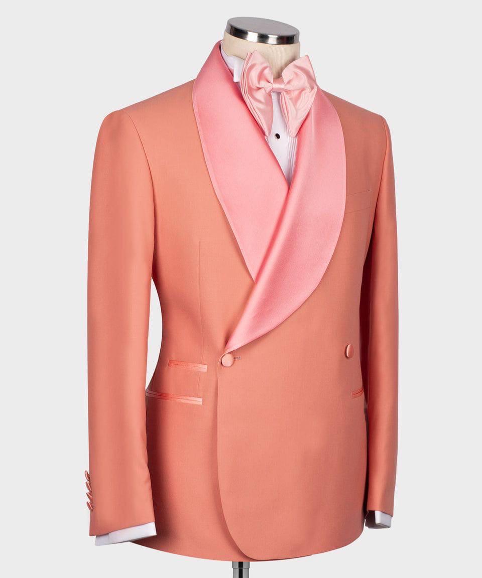 A peach-colored men's tuxedo jacket with a contrasting light pink satin shawl collar, worn by a mannequin styled with a matching pink bow tie and white dress shirt.