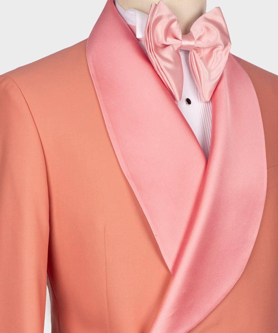 Mannequin wearing a peach suit with a pink cravat against a white background