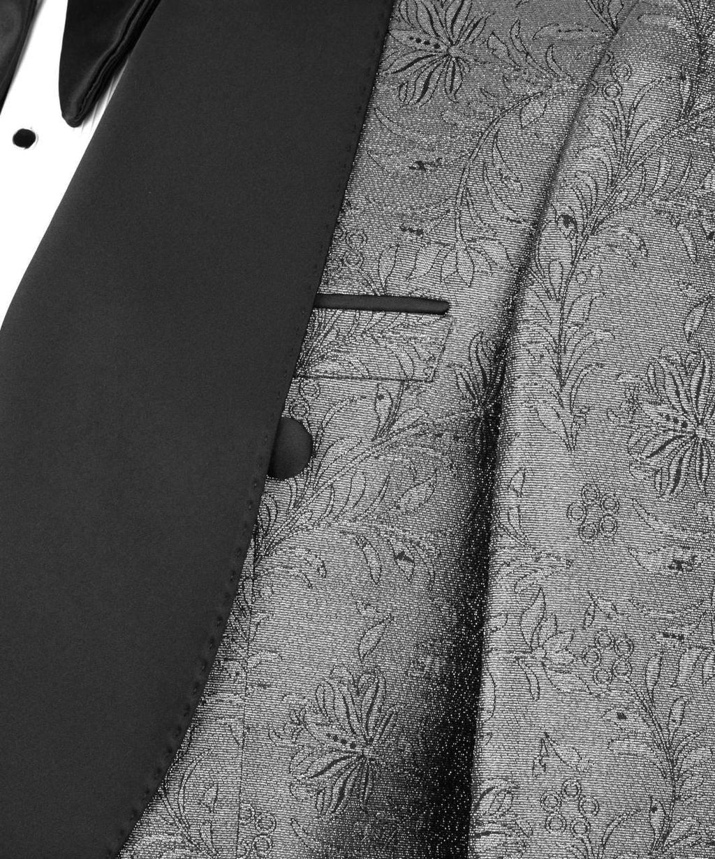 Close-up of a suit with floral patterned lapel and black lapels.