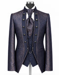 A men's formal tailoring set displayed on a mannequin, featuring a textured navy blue patterned jacket, matching vest, waistcoat, and tie, with a white shirt and dark navy trousers.