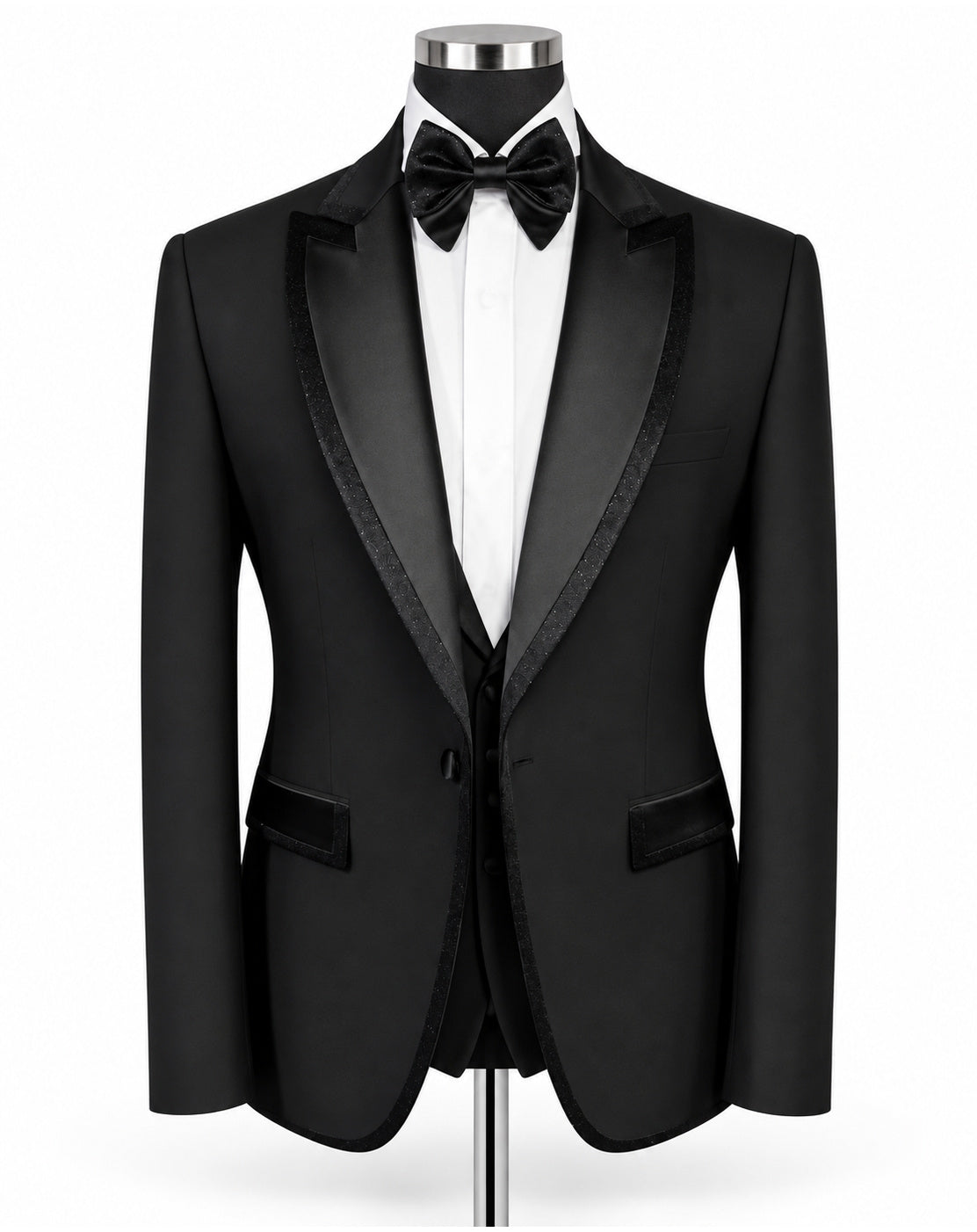 A black tuxedo jacket with satin lapels, displayed on a mannequin torso with a white dress shirt, black bow tie, and matching vest against a plain white background.