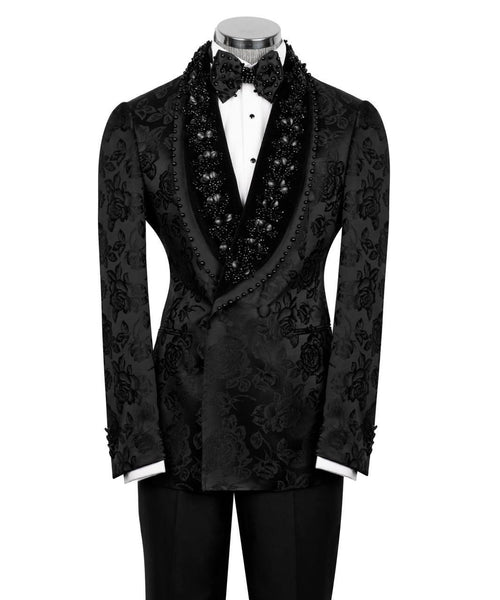 A black patterned tuxedo jacket with a shawl collar embellished with black beads and sequins, styled on a mannequin with a black bow tie, white dress shirt, and black trousers against a white background.