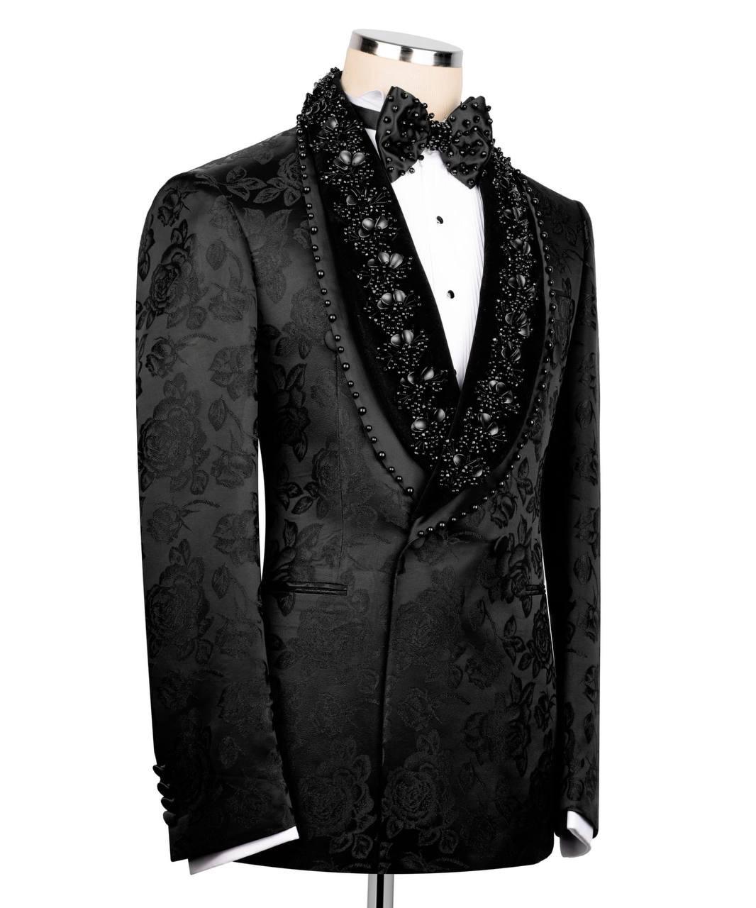 Black formal suit with floral patterns on a mannequin against a white background