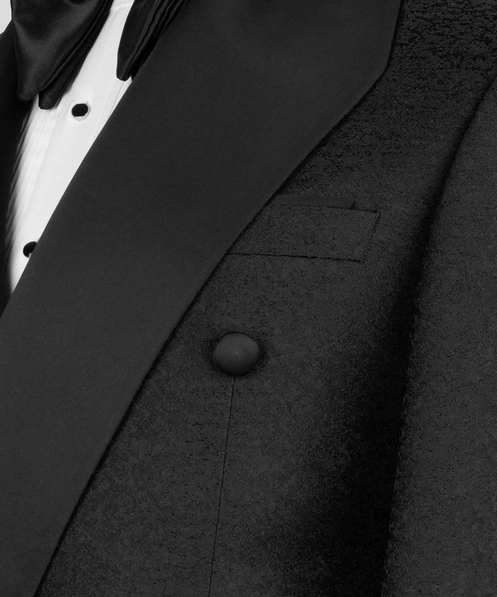 Close-up of a black tuxedo jacket with a button