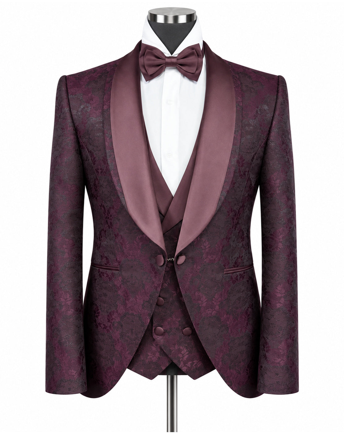 A men's formal tuxedo jacket with matching waistcoat vest, displayed on a mannequin with a white dress shirt and matching burgundy bow tie. The jacket features a subtle damask pattern in deep burgundy and purple, with satin shawl lapels.