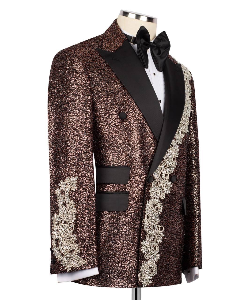 Elegant tuxedo with decorative patterns on a mannequin against a white background