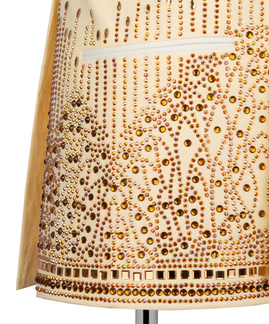 Beige lampshade with gold rhinestone embellishments on a white background