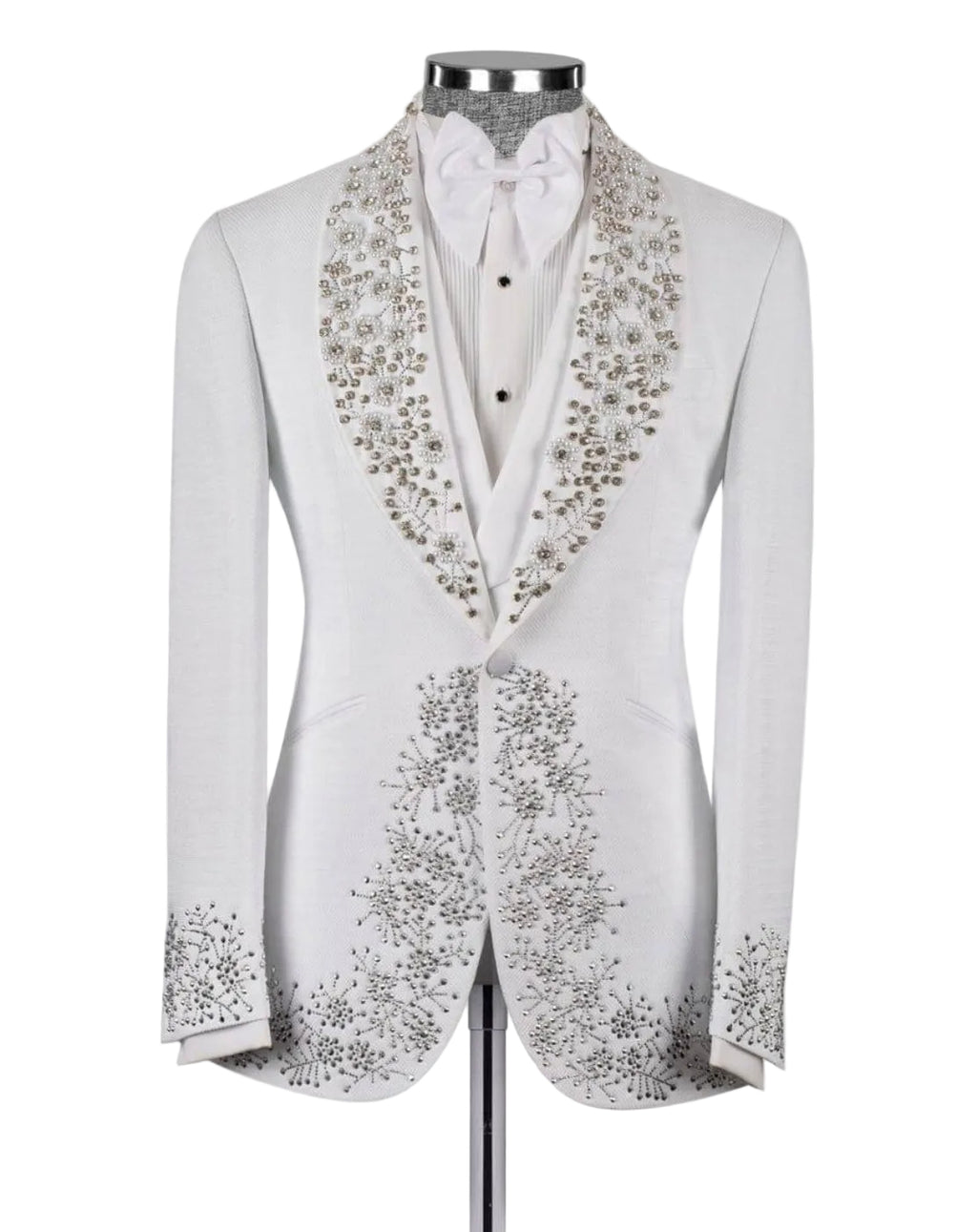 A white tuxedo jacket with elaborate silver and gold floral beadwork on the shawl collar and front panels, displayed on a mannequin with a white shirt and bow tie against a light gray background.