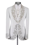 A white tuxedo jacket with elaborate silver and gold floral beadwork on the shawl collar and front panels, displayed on a mannequin with a white shirt and bow tie against a light gray background.