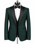 A men's formal tuxedo jacket in dark green textured tweed with black satin shawl lapels, displayed on a black mannequin torso with a white dress shirt, black bow tie, and matching black vest.