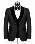 A black tuxedo jacket displayed on a mannequin torso with a black velvet vest, white dress shirt, black bow tie, and black bowler hat against a plain white background.