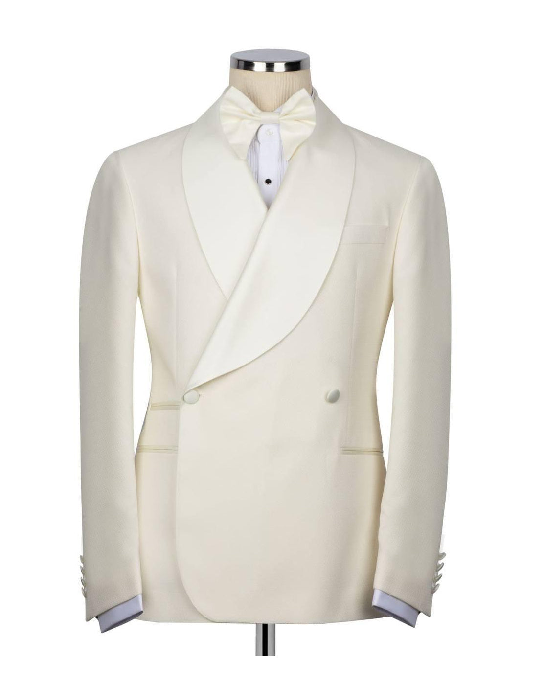 An ivory double-breasted tuxedo jacket with a shawl collar, displayed on a mannequin with a matching bow tie and white dress shirt against a plain white background.