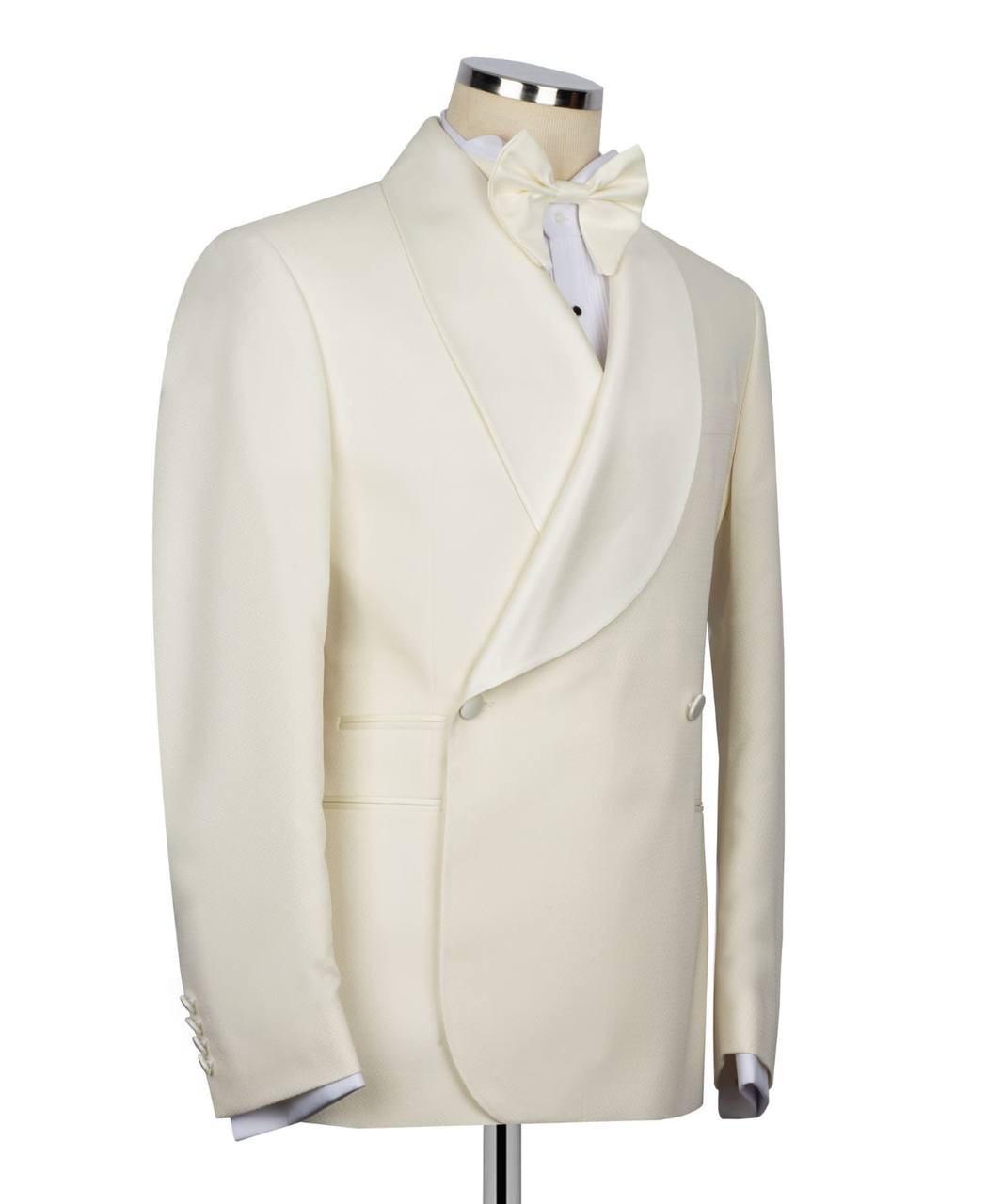 White tuxedo jacket on a mannequin with a white shirt and bow tie against a white background