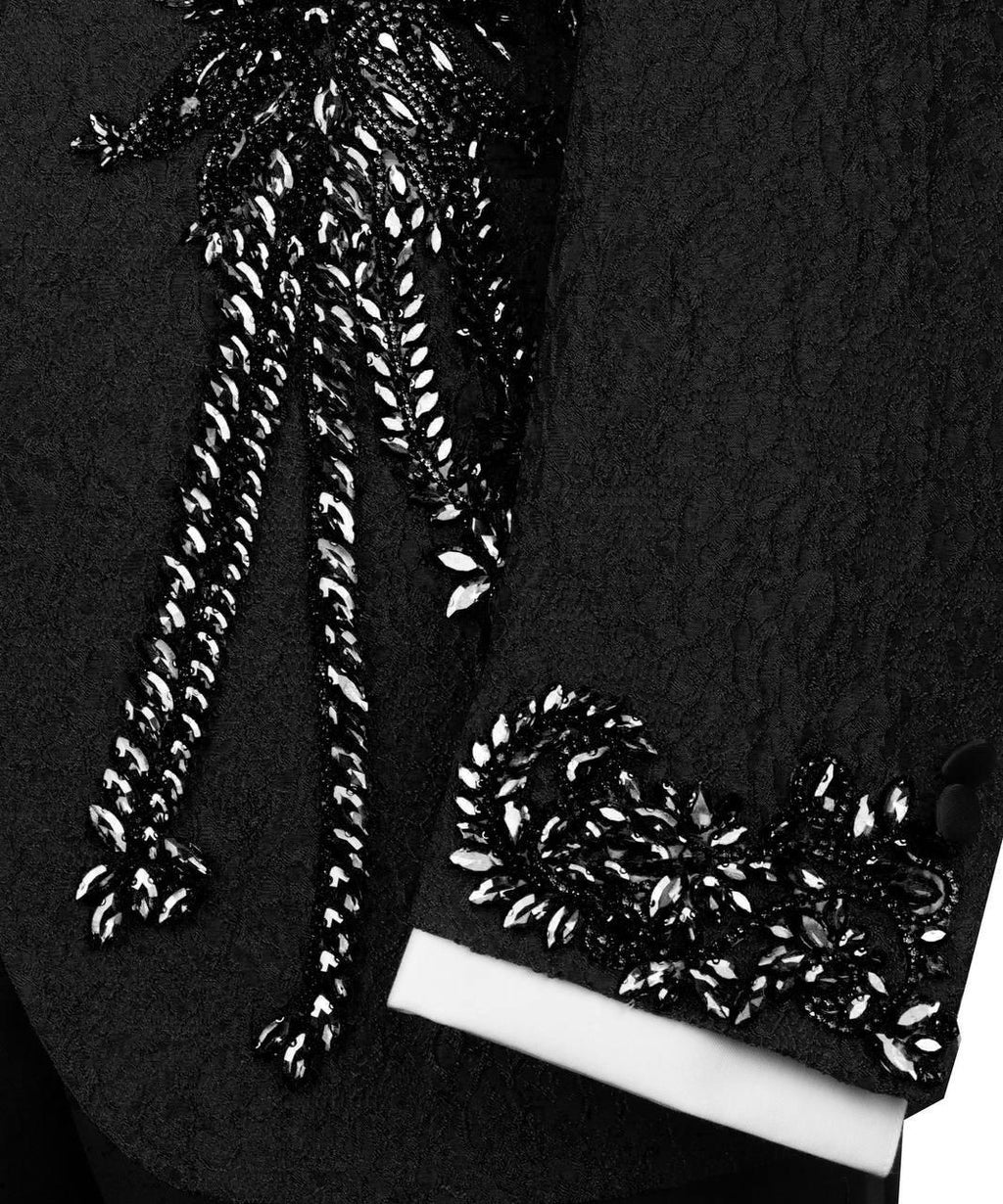 Black high-heeled shoes with silver embellishments on a dark background