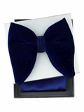 A dark navy blue velvet bow tie presented with a matching navy blue pocket square and a white presentation card inside a black gift box, set against a plain white background.