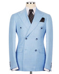 A light blue double-breasted suit jacket displayed on a mannequin torso, styled with a white dress shirt, a dark patterned tie, and a matching pocket square against a plain white background.