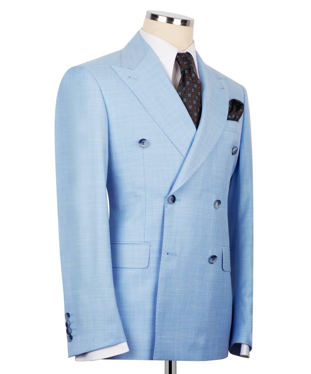 A light blue double-breasted suit jacket displayed on a mannequin torso, styled with a white dress shirt, a dark patterned tie, and a matching pocket square against a plain white background.
