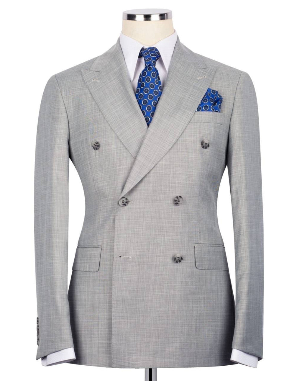 Gray checkered suit jacket with a blue patterned tie and pocket square on a mannequin 