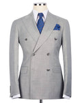 Gray checkered suit jacket with a blue patterned tie and pocket square on a mannequin 